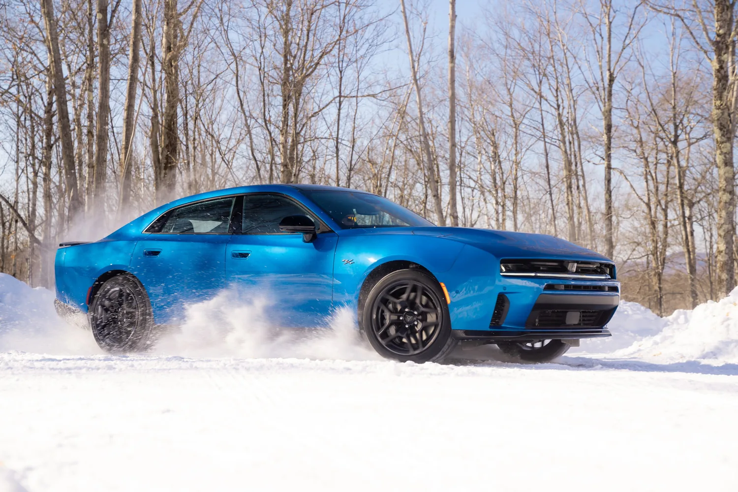 Blue 2026 Dodge Charger R/T driving on snow, an official civilian platform image